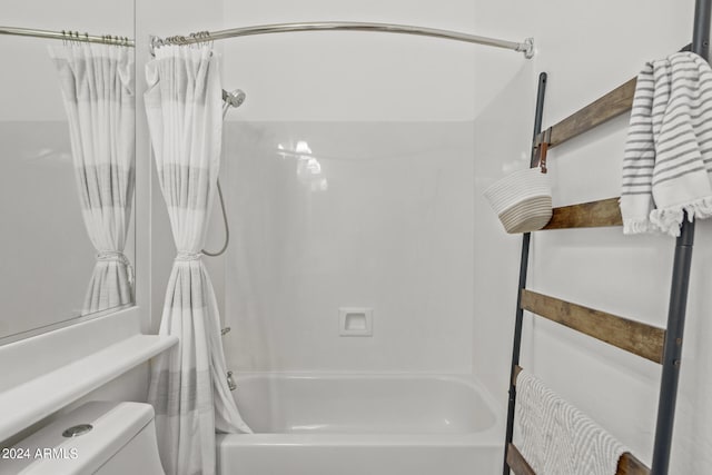 bathroom featuring toilet and shower / tub combo with curtain