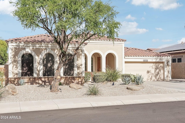 mediterranean / spanish-style house with a garage