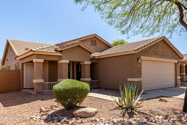 single story home with stucco siding, driveway, an attached garage, a tile roof, and fence