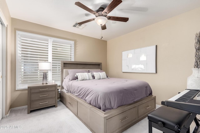 bedroom with visible vents, baseboards, a ceiling fan, and light colored carpet