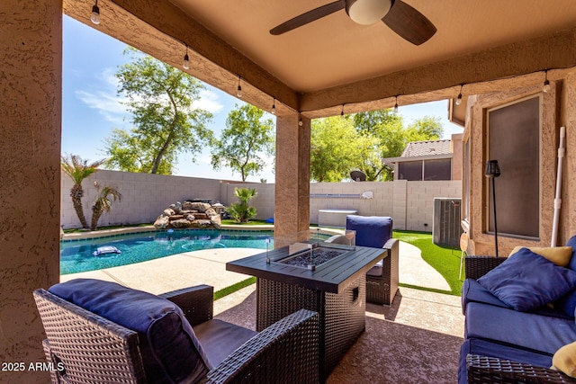 view of patio with a fenced in pool, a fire pit, a fenced backyard, and central AC unit