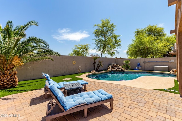 view of swimming pool with a patio area, a fenced backyard, and a fenced in pool