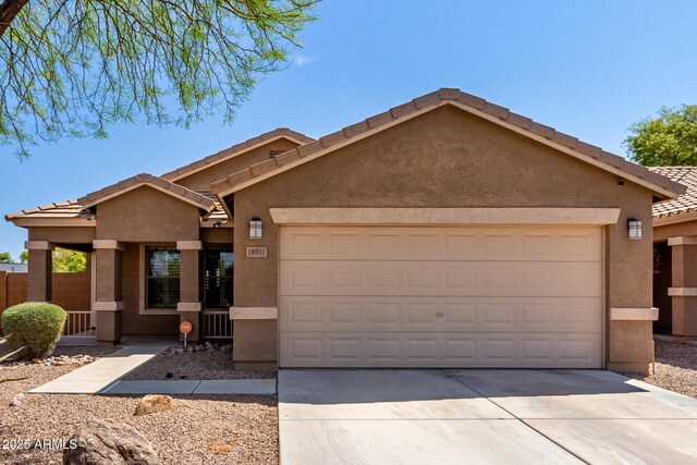 ranch-style house featuring a garage, driveway, stucco siding, and a tile roof