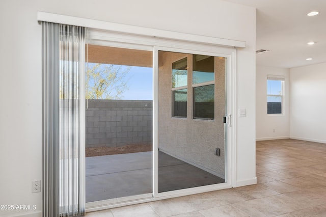 doorway to outside with light tile patterned flooring