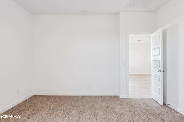 unfurnished room featuring light carpet