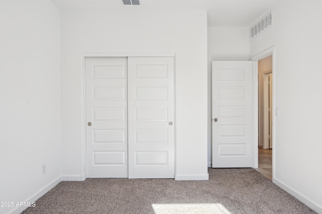 unfurnished bedroom featuring carpet floors and a closet