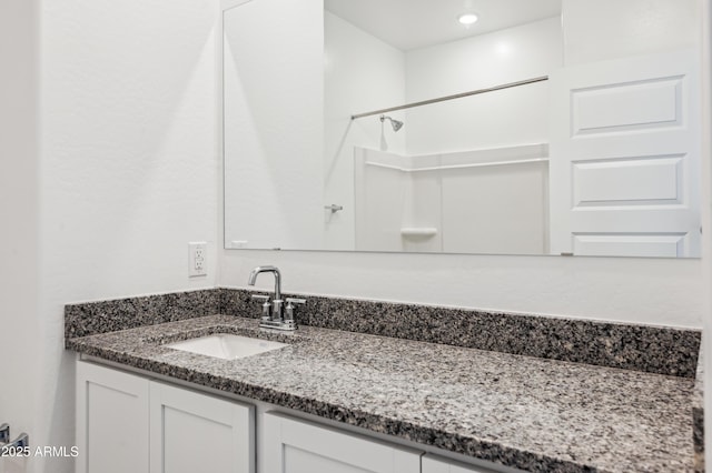 bathroom with vanity and walk in shower