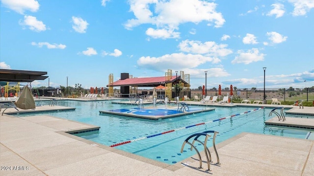 view of pool featuring a hot tub and a patio