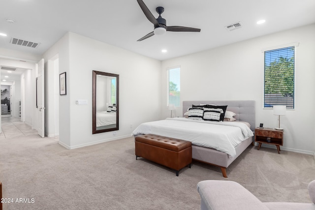 carpeted bedroom with multiple windows and ceiling fan