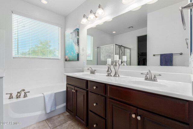 bathroom with plus walk in shower, tile patterned floors, and vanity