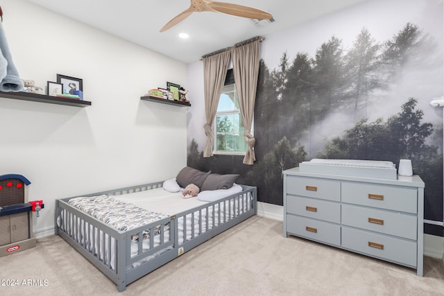 bedroom with light carpet and ceiling fan