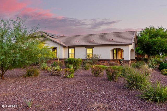 view of back house at dusk