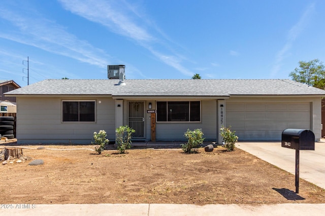 18427 N 32nd Ln, Phoenix, AZ 85053 - ranch-style home featuring a garage, driveway, cooling unit, and a shingled roof