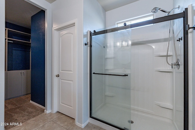 bathroom featuring tile patterned flooring and a shower with door