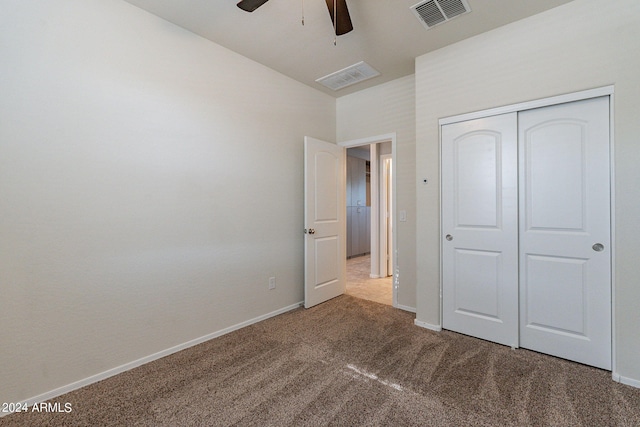 unfurnished bedroom with carpet floors, a closet, and ceiling fan