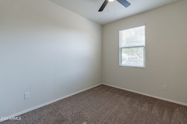 spare room featuring carpet and ceiling fan