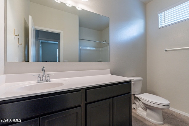 bathroom featuring a shower, tile patterned floors, vanity, and toilet