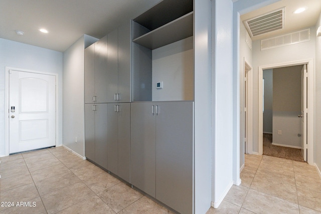 hall featuring light tile patterned floors