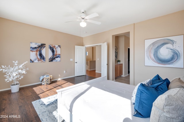 bedroom with connected bathroom, ceiling fan, and dark wood-type flooring