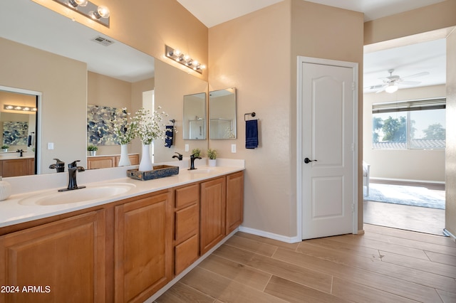 bathroom featuring vanity, ceiling fan, and wood-type flooring