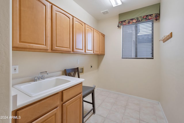 washroom with hookup for an electric dryer, washer hookup, cabinets, gas dryer hookup, and sink