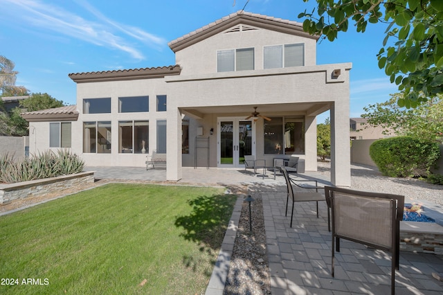 back of property featuring french doors, a patio, ceiling fan, and a yard