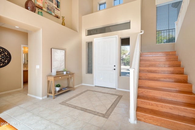 tiled foyer with a high ceiling