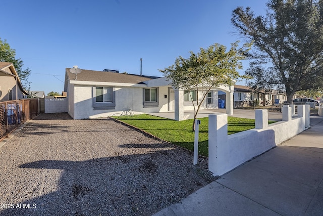 ranch-style home with a front lawn