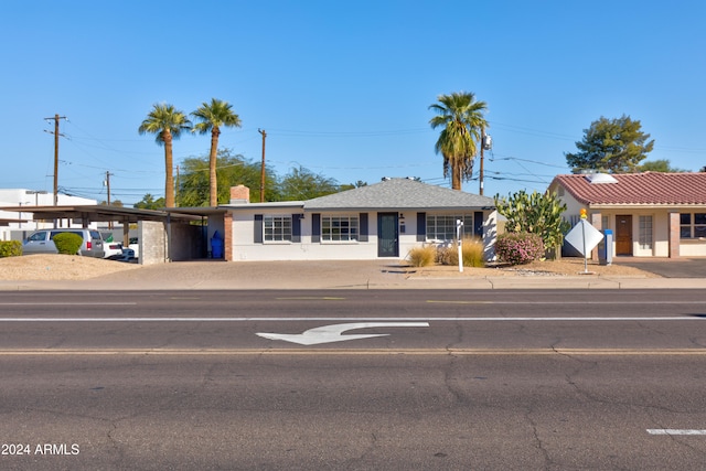 ranch-style house featuring a carport