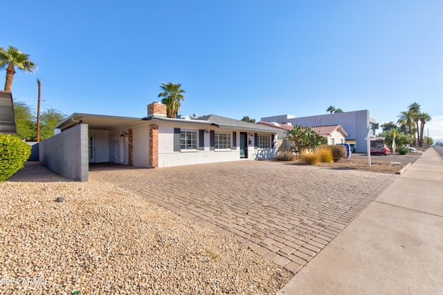 single story home featuring a carport