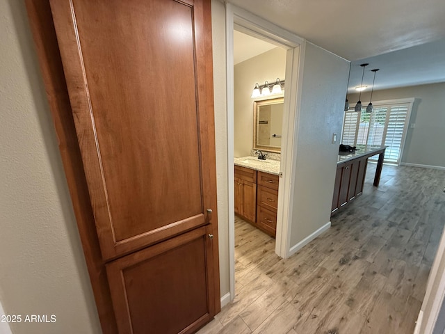 5525 E Thomas Rd Unit C2, Phoenix, AZ 85018 - hallway with light wood-type flooring and a sink