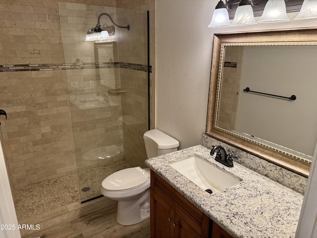 5525 E Thomas Rd Unit C2, Phoenix, AZ 85018 - full bath with vanity, a tile shower, wood finished floors, and a textured wall