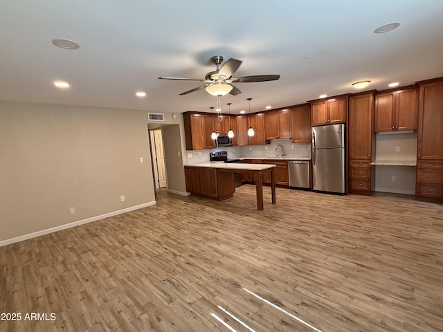 5525 E Thomas Rd Unit C2, Phoenix, AZ 85018 - kitchen with stainless steel appliances, light countertops, light wood-style floors, ceiling fan, and recessed lighting