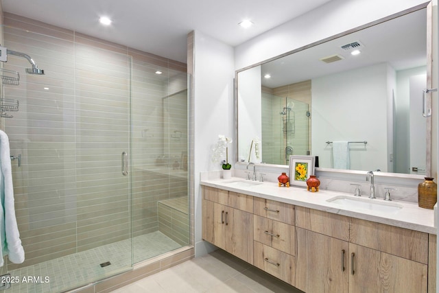 bathroom with vanity, an enclosed shower, and tile patterned floors