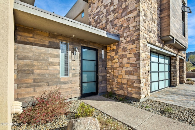 doorway to property with a garage