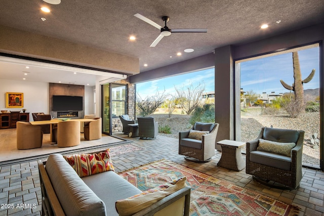 interior space with ceiling fan and a textured ceiling