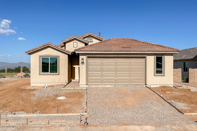 view of front facade with a mountain view and a garage