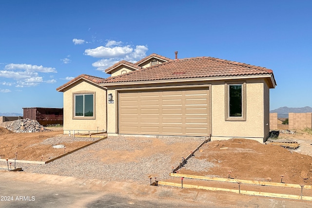 view of front of property with a mountain view and a garage