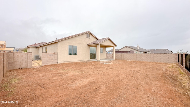 rear view of house featuring central AC unit