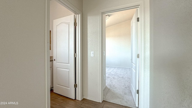 hallway with light colored carpet