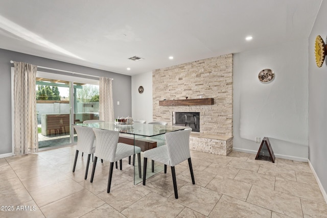 dining room featuring a fireplace, recessed lighting, baseboards, and visible vents