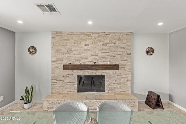 dining space with a stone fireplace, recessed lighting, baseboards, and visible vents