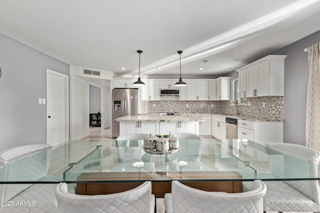 dining room with recessed lighting and visible vents