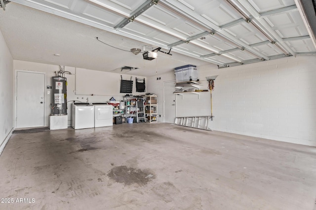 garage featuring water heater, independent washer and dryer, and a garage door opener