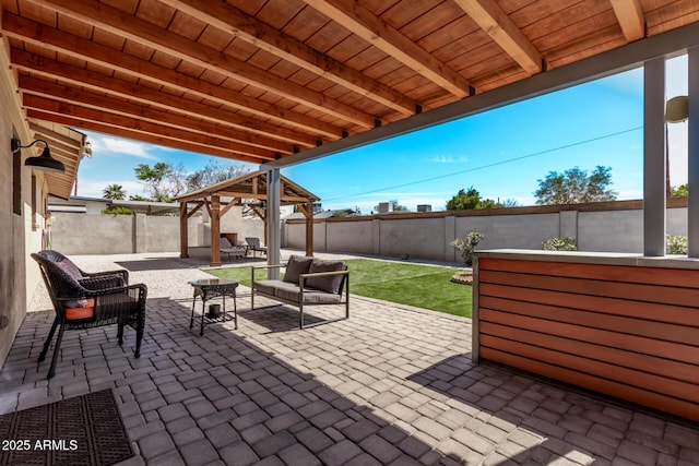 view of patio / terrace with a gazebo, an outdoor living space, and a fenced backyard