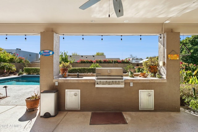 view of patio featuring ceiling fan, sink, an outdoor kitchen, grilling area, and a fenced in pool