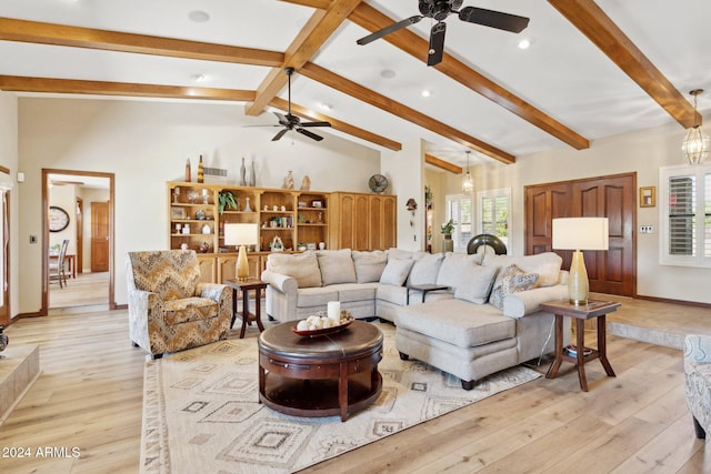 living room featuring a wealth of natural light, lofted ceiling with beams, and light hardwood / wood-style floors