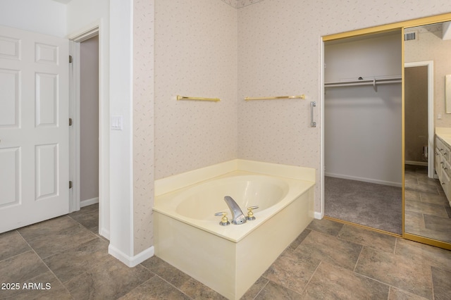 bathroom with vanity and a tub