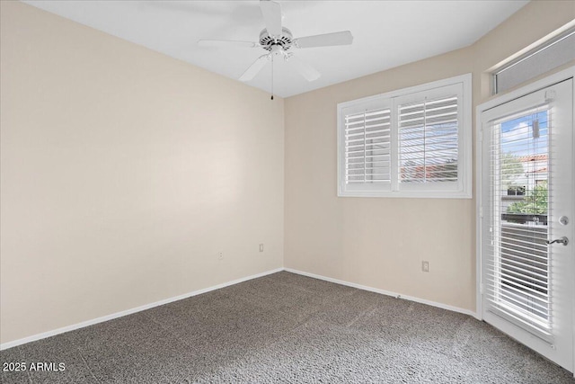 empty room with baseboards, carpet floors, and a ceiling fan