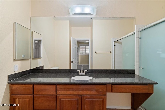 bathroom with a stall shower and vanity